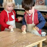 Indiana Montessori Academy Photo #4 - Two IMA children work together on Table Scrubbing.