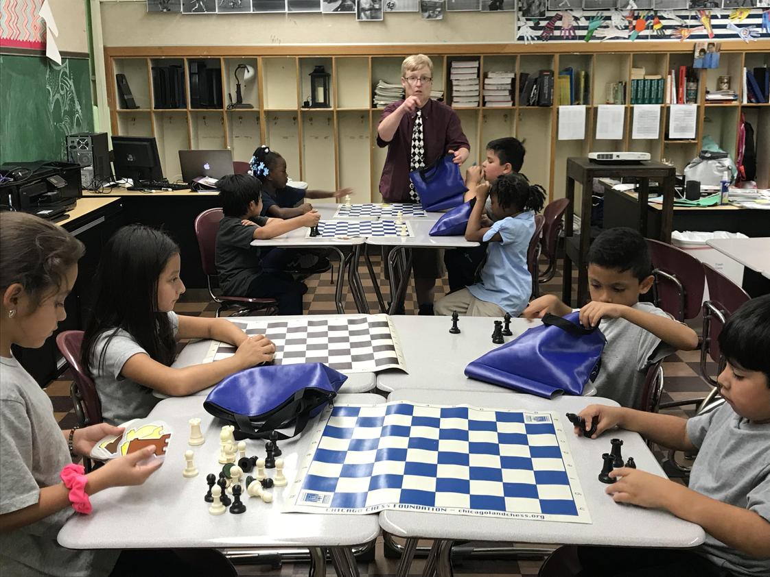 Altus Academy Photo #1 - Coach Conor working with the 1st-3rd grade students in Chess Class. Altus Academy is a big proponent of project-based learning.