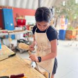 The Logan School for Creative Learning Photo #9 - A student studying agriculture works in the Logan Works project lab designing a hand made tool.