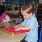 Boulder Knoll Montessori School Photo #3 - Practicing the life skill of buttoning.
