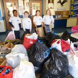 Assumption Catholic School Photo #3 - Our students, staff, faculty and parents are committed to giving back to the community. In honor of Catholic Schools Week, our families donated winter clothing to St. Charles/St. Mary's Outreach Center. Here our students are with the bags of clothing that were donated.