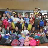 St. Joseph High School Photo #9 - Service is a core piece of our SJHS curriculum. Students take time out of their summer to volunteer to fill backpacks for elementary school students. All items were donated by SJ families.