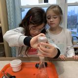 Mountainside Montessori Photo #4 - In Montessori, the work of the children is hands-on and independent in nature. Two Lower Elementary students prepare and execute their Science experiment which they will later document and share.