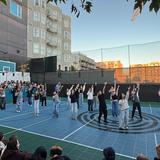 Millennium School Of San Francisco Photo #10 - A Culmination Evening dance performance for the community on our Sports Court as the sun sets in the distance.