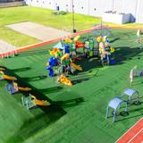 LIH- Lycée International de Houston Photo #10 - Young students enjoy a dedicated outdoor playground designed for safe, active play and exploration, fostering both fun and learning in an open-air environment