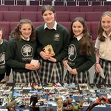 Adolesco Preparatory Academy Photo #7 - Students looking at African missions memorabilia at monthly Rise&Shine assembly where parents and grands join the school to worship together and hear guest speakers, everyone from international missionaries and local leaders to students presenting their projects.