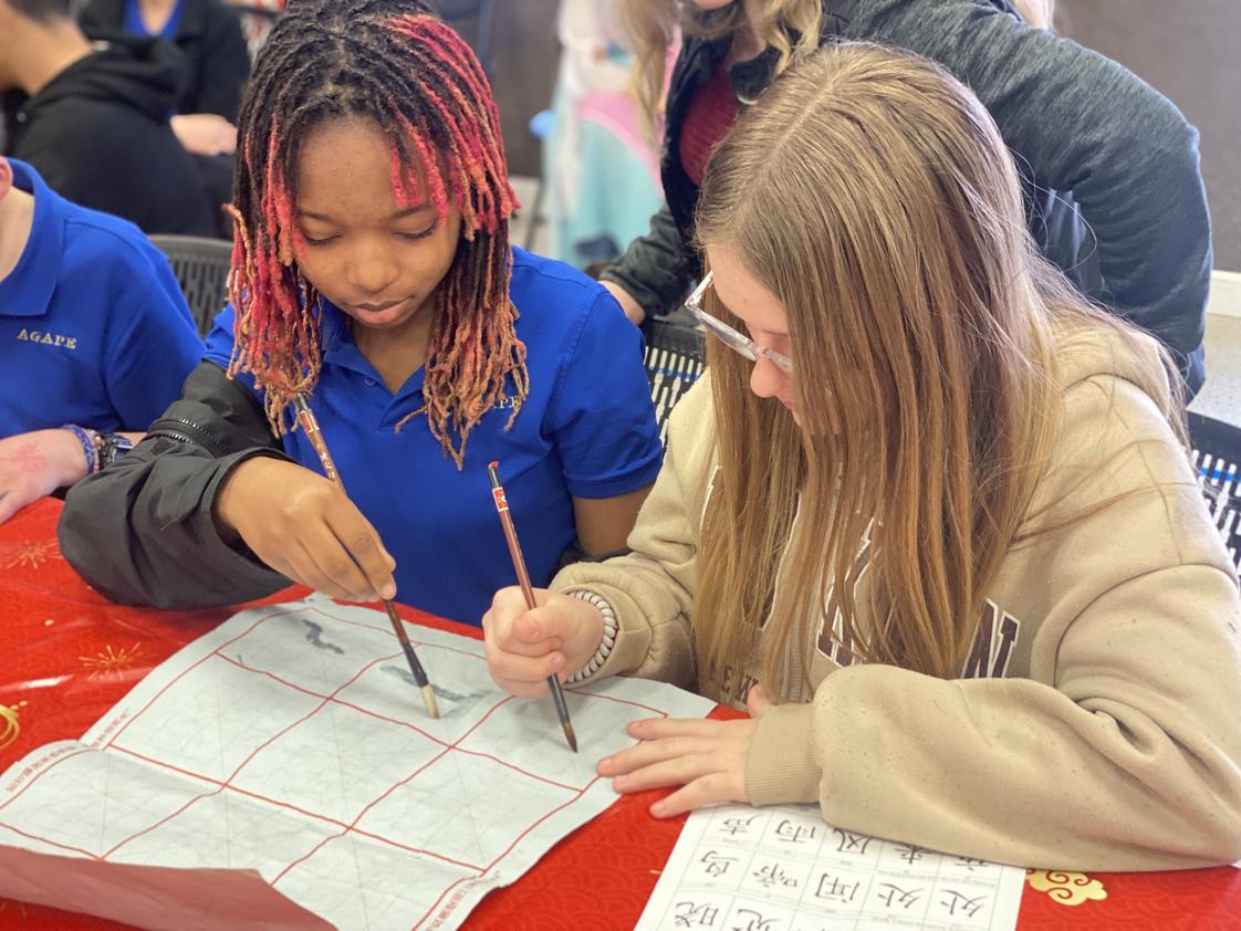 Port Haven International Academy Photo #1 - Chinese New Year Celebration learning how to draw Chinese Characters.