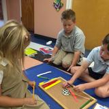 Blessed Star Montessori Christian School Photo #6 - Hands on Geometry lesson with Montessori materials.