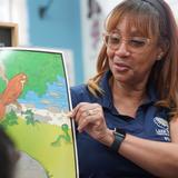 Lake Rose Christian Academy Photo #13 - A Lake Rose Christian Academy teacher engages students during a classroom lesson, holding up a colorful visual aid to bring learning to life.