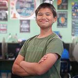 Lake Rose Christian Academy Photo #20 - A Lake Rose Christian Academy student stands confidently in the classroom, surrounded by a focused learning environment.