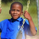 Lake Rose Christian Academy Photo #15 - A Lake Rose Christian Academy student enjoys a moment on the playground, holding the swing with a look of focus and excitement.