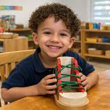 Montessori Children's Academy Photo #5 - A young child practices independence and finemotor coordination by learning to tie laces using a Montessori dressing frame. This handson activity builds confidence, concentration, and reallife readiness-core values we nurture every day at Montessori Children's Academy.
