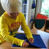 Oak Grove Montessori School Photo - Practical life skills, such as buttoning, develop fine-motor muscles and coordination important for handwriting.