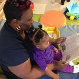 Country Club Hills KinderCare Photo #1 - Ms. Samantha reading to one of the infants.