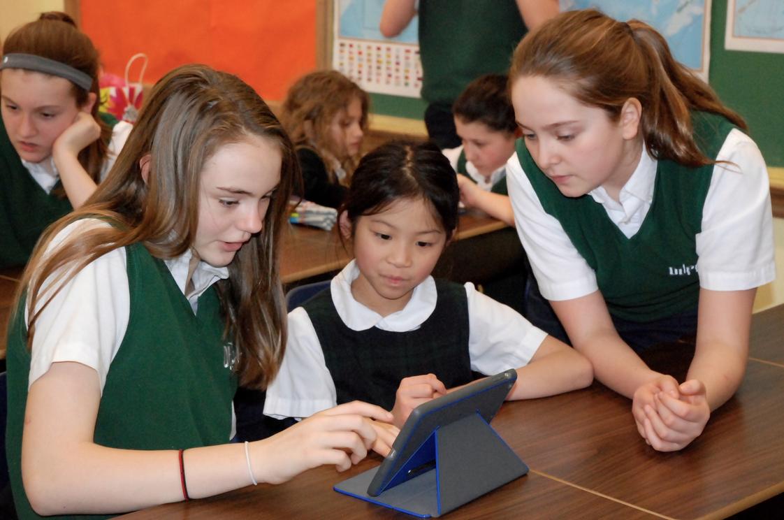 Our Lady Of Perpetual Help Photo #1 - Our 7th grade and 1st grade buddies work on a project together with iPads.