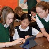 Our Lady Of Perpetual Help Photo - Our 7th grade and 1st grade buddies work on a project together with iPads.