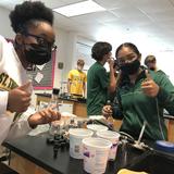 The High School Of Saint Thomas More Photo #3 - Onyi Okolo and Leilani Sayavongsa take a break from their chemistry lab to smile for the camera.