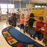 Meyers Road KinderCare Photo #6 - The preschool class is walking over the bridge they colored together.